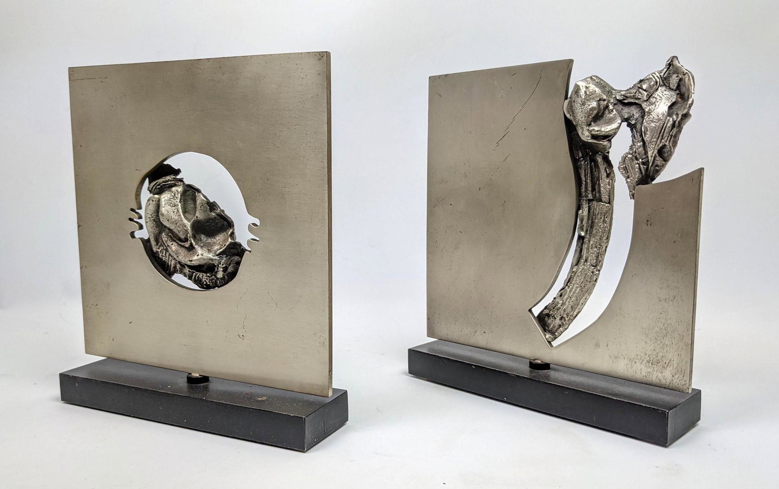 Pr Stainless Sculptural Panel Sculptures. Central Sculp: Pr Stainless Sculptural Panel Sculptures. Central Sculptural Details. Panels swivel on bases. -- Dimensions: H: 9 inches: W: 8 inches ---