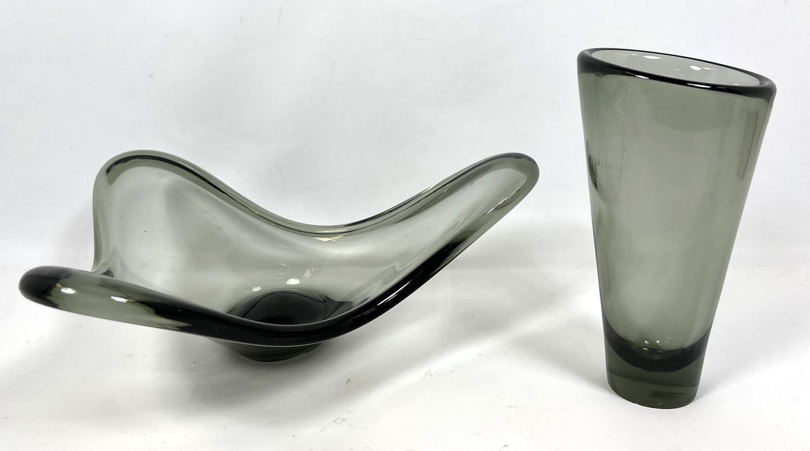 2pc PER LUTKEN for HOLMEGAARD Smoky Art Glass. 1). Thre: 2pc PER LUTKEN for HOLMEGAARD Smoky Art Glass. 1). Three Lobed Sculptural Bowl. Signed, dated 1962. 2). Tall Cone form Vase; signed. -- Dimensions: H: 6 inches: W: 16 inches: D: 14 inches ---