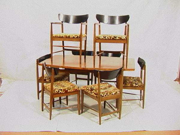 American Modern Walnut Dining Table And 8 Chairs.: American Modern Walnut Dining Table And 8 Chairs. Bowed side table. Chairs with ebonized black tops. 2 arm and 6 sides. Dimensions: Condition (General): Shows some overall wear.Please contact us with