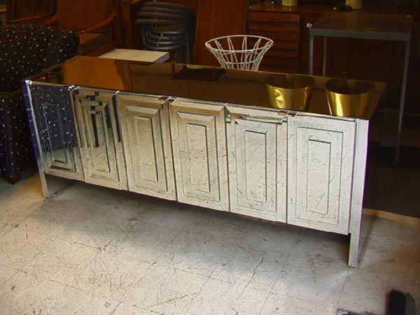 Six Door Beveled Mirror Credenza Sideboard. Each: Six Door Beveled Mirror Credenza Sideboard. Each Door with Layered Beveled Mirror Panels. Mirror Top. Mirrored Chrome Sides. Dimensions: H: 29.75 inches: D: 21 inches: L: 75.25 inches Condition (Gener