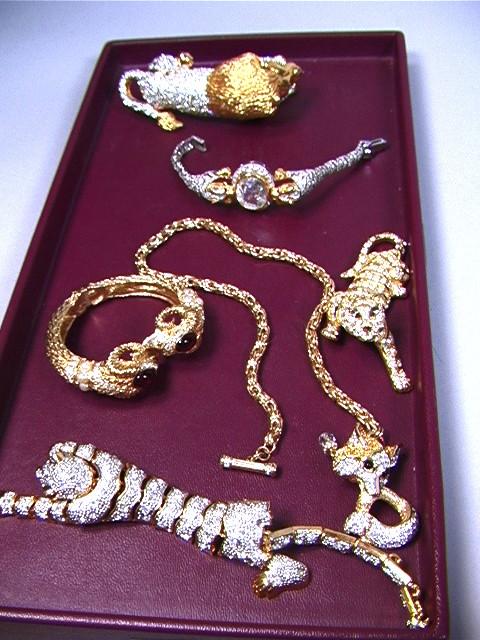 6 PCS Costume Jewelry: 2 Leopard Bracelets. Lion: 6 PCS Costume Jewelry: 2 Leopard Bracelets. Lion and Leopard Pins. Rams Head Hinged Bracelet. Swarovski Crystal Fox Chain Necklace, marked. Trifari Leopard Pin, marked. 6 PCS-- Dimensions: --- Conditi