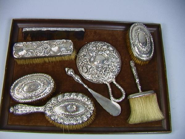 8 pcs STERLING Dresser Pieces: TIFFANY & Co. Hand: 8 pcs STERLING Dresser Pieces: TIFFANY & Co. Handled Brush, (monogram and dent to center). Sterling GORHAM Hand Mirror with Repousse design, (few small dents to rim). Two GORHAM Oval Brushes with mono