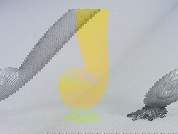 LOETZ Favrile style Art Glass Shell Form Vase on: LOETZ Favrile style Art Glass Shell Form Vase on Feet. Iridescent Amber colored glass in organic form. Iridescent Green Footed glass base. unmarked.-- Dimensions: H: 10 inches: W: 5 inches: D: 3.75 in