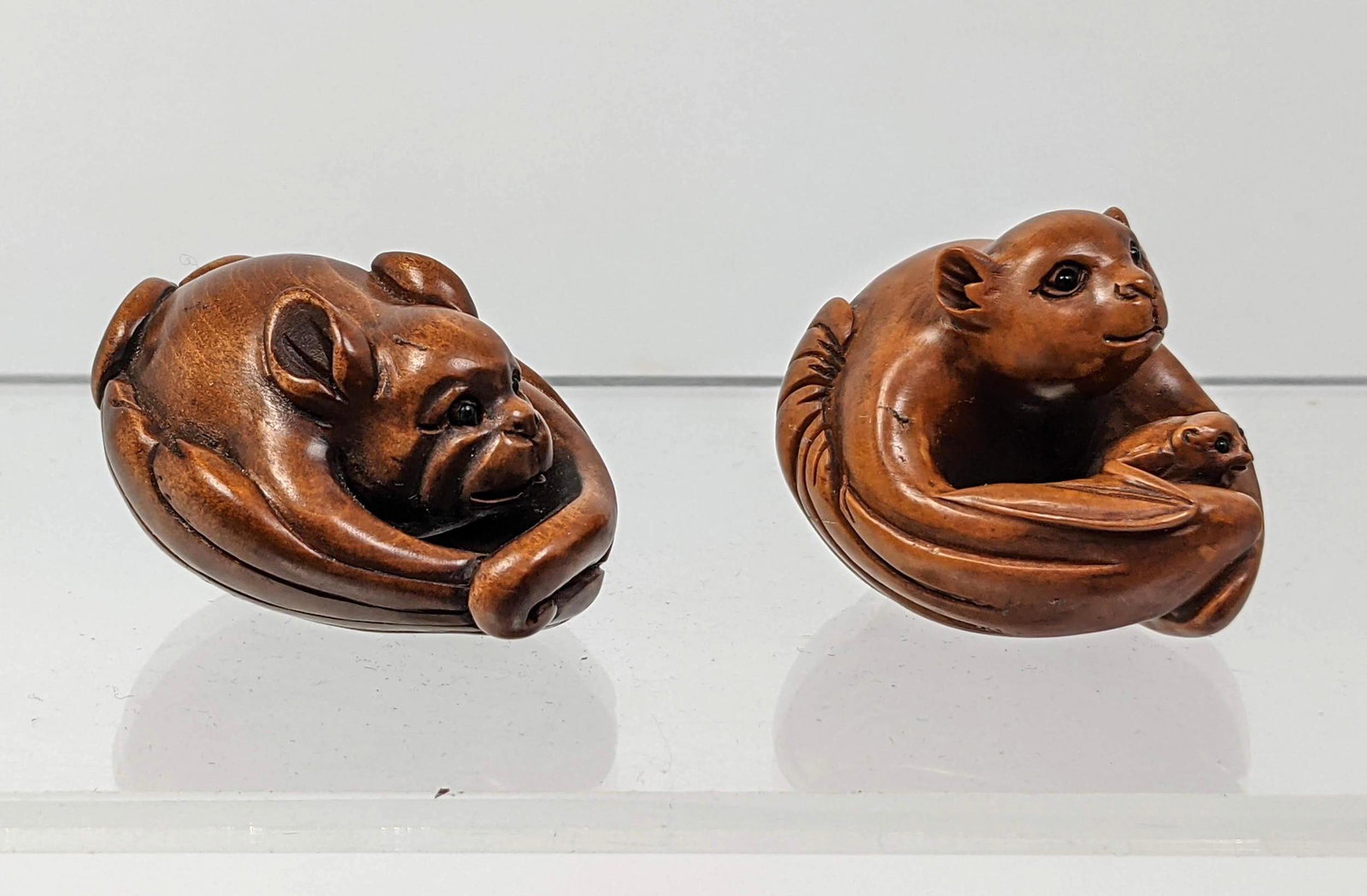 2pc Carved Wood Netsukes. 1). Carved Bat with baby. 2).: 2pc Carved Wood Netsukes. 1). Carved Bat with baby. 2). Carved dog. Both signed-- Dimensions: H: 1.25 inches: W: 1.75 inches: D: 1.5 inches --- US Shipping charge: $35 Plus insurance at a rate of $1 p