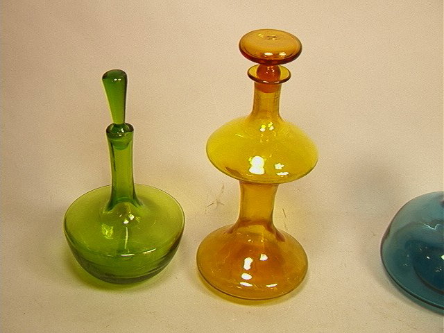 2pcs Blenko Bottle Vases. Green and Amber. Both: 2pcs Blenko Bottle Vases. Green and Amber. Both Stoppered.-- Dimensions: H: 14 inches: W: 6 inches: D: 6 inches --- Condition (General): Very Good Condition. Please contact us with specific questions 