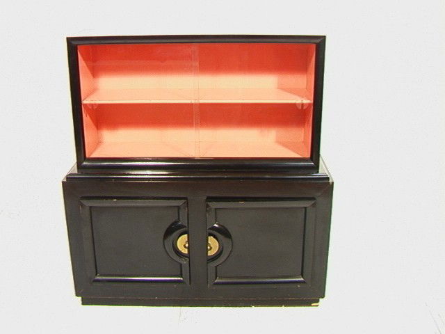 Paul laszlo China Cabinet. Ebonized with Peach in: Paul laszlo China Cabinet. Ebonized with Peach interior. Glass sliding doors.-- Dimensions: H: 51 inches: W: 48 inches: D: 15.5 inches --- Condition (General): Some losses to black. Some chips to vene