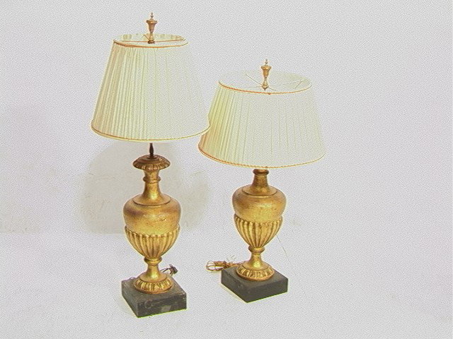 Pr Carved Wood Urn Form Table Lamps. Gilt antique: Pr Carved Wood Urn Form Table Lamps. Gilt antiqued bases sit on square blocks. 2 PCS.-- Dimensions: H: 33 inches: W: 7 inches: D: 7 inches --- Condition (General): Lamps are identical. Different heigh