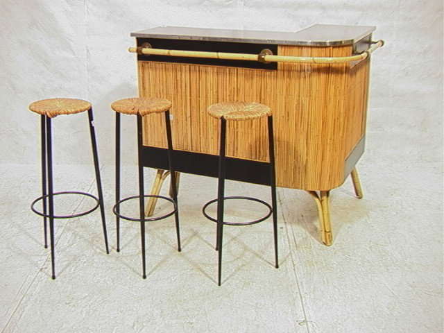 Modernist Rattan Bar and Bar Stools. L shaped bar: Modernist Rattan Bar and Bar Stools. L shaped bar with reeded front. 3 bar stools with rush sets.-- Dimensions: H: 40.5 inches: W: 48 inches: D: 36 inches --- Condition (General): Some surrfae scratch