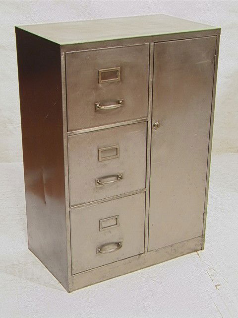 Industrial Metal Three Drawer File Cabinet. One D: Industrial Metal Three Drawer File Cabinet. One Door. Steel Frame Cabinet with brushed steel finish.-- Dimensions: H: 40 inches: W: 27 inches: D: 16 inches --- Condition (General): Very Good Used Cond