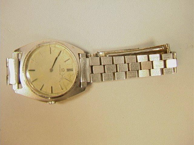 Omega 14K Gold Watch. White gold.: Omega 14K Gold Watch. White gold. -- Dimensions: H: 1.25 inches: W: 1.2 inches --- Condition (General): Discoloration to face. Please contact us with specific questions about condition, not visible in