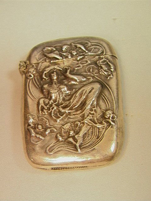 Art Nouveau Sterling Match Safe. Woman with flow: Art Nouveau Sterling Match Safe. Woman with flowing dress. Poppies.-- Dimensions: H: 2.5 inches: W: 1.75 inches: D: 0.4 inches --- Condition (General): A few tiny dents Please contact us with specific