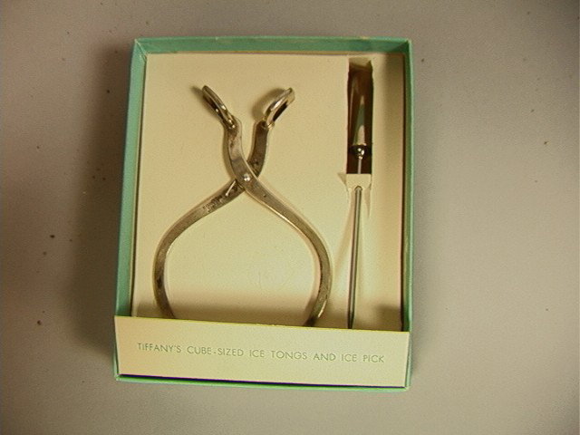 TIFFANY & CO. Sterling Ice Tongs and Pick. Boxed.: TIFFANY & CO. Sterling Ice Tongs and Pick. Boxed. Cube sized Ice tongs and ice pick. Mint in Box. Marked.-- Dimensions: --- Weight: 1.7 Troy ozs. ---- --- Condition (General): Very Good Condition. Box