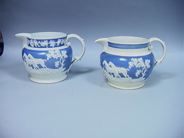 2 pc Jasperware Pitchers with Hunt scenes. Not si: 2 pc Jasperware Pitchers with Hunt scenes. Not signed but possibly Wedgwood.-- Dimensions: H: 5.75 inches: W: 9 inches --- Condition (General): Good condition. Please contact us with specific question