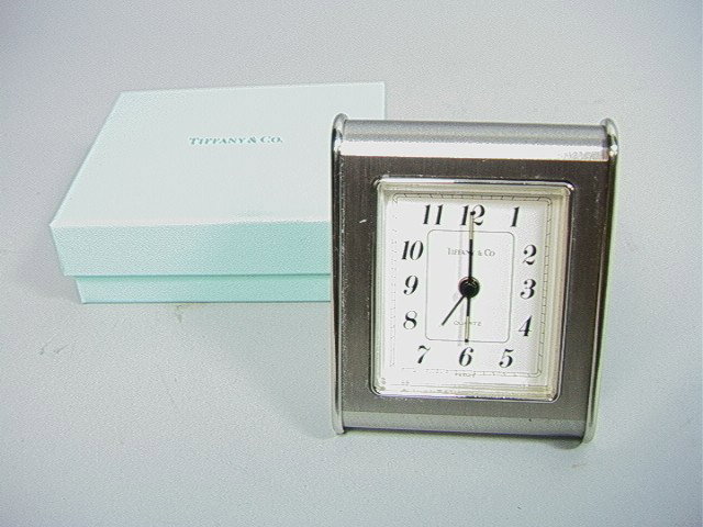 Tiffany Lot. Two table clock and a pen. 4.5" br: Tiffany Lot. Two table clock and a pen. 4.5" brass swivel clock, A 3.25" silver color A frame clock with box(missing battery cover), and A pen with box and bag (PEN NOT MARKED)-- Dimensions: --- Pleas