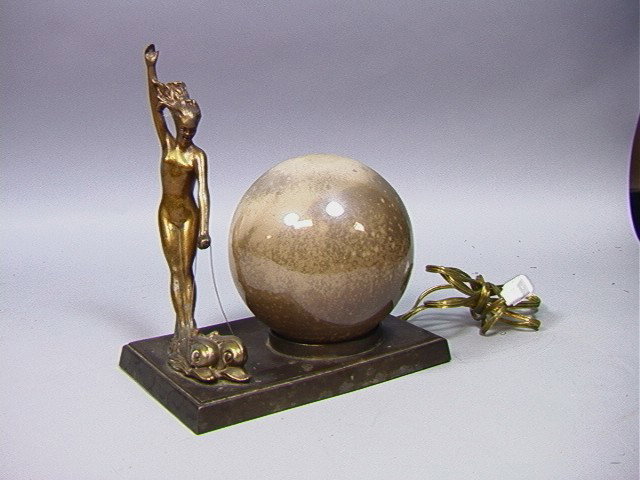 Art Deco lamp of Woman Riding Dolphins.: Art Deco lamp of Woman Riding Dolphins.-- Dimensions: H: 10 inches: W: 9 inches --- Condition (General): Some blemishes on metal. Losses to interior shade paint. Please contact us with specific questi