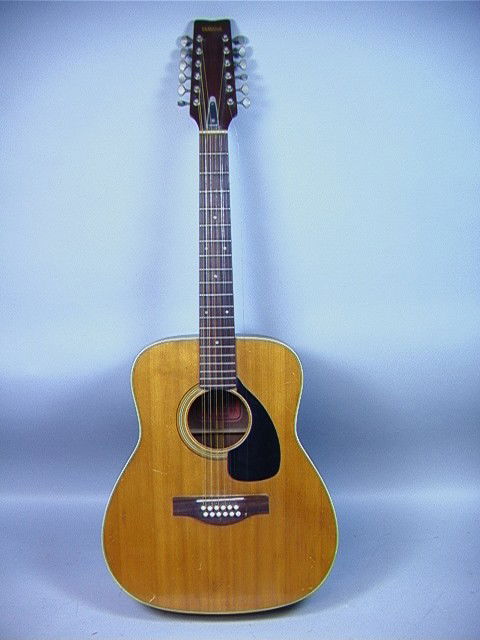 YAMAHA FG-230 Acoustic Guitar. 12 String Classic: YAMAHA FG-230 Acoustic Guitar. 12 String Classical guitar with stand.-- Dimensions: : W: 16 inches: D: 3.75 inches: L: 42.5 inches --- Condition (General): Good condition. Shows overall use. One strin