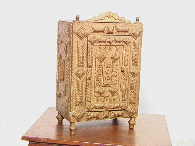 1907 Tramp Art Cabinet. Gold Painted Lucas signed: 1907 Tramp Art Cabinet. Gold Painted Lucas signed.-- Dimensions: H: 23 inches: W: 16 inches: D: 11 inches --- Condition (General): Legs crooked, has minor overall losses. Please contact us with specif