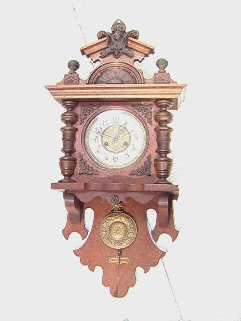 Carved Victorian Walnut wall clock.: Carved Victorian Walnut wall clock.-- Dimensions: H: 33 inches: W: 16 inches --- Condition (General): Good condition. Not tested. Crazing to face. Please contact us with specific questions about condi