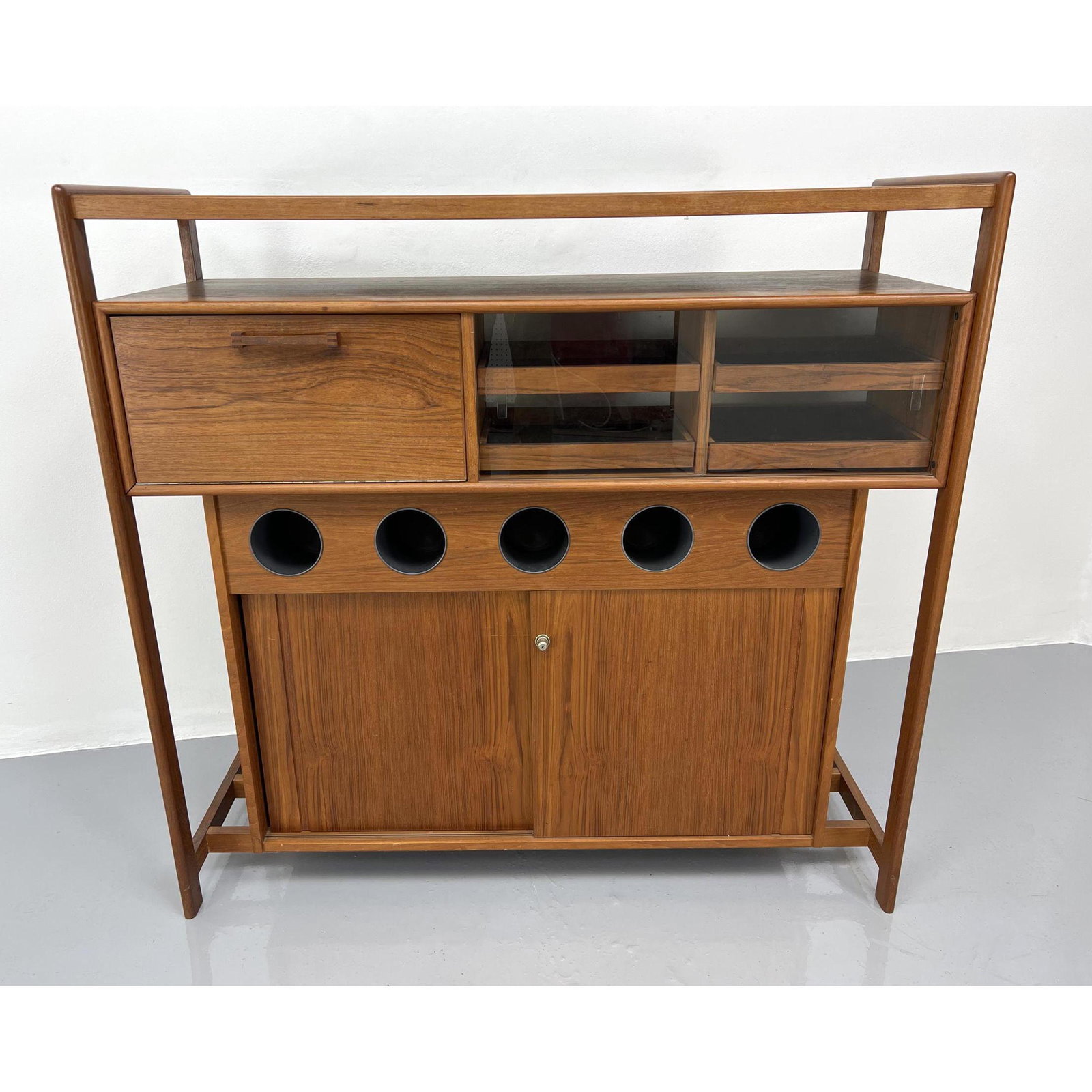 Danish Modern Teak Bar Cabinet. Cubbies for wine bottle: Danish Modern Teak Bar Cabinet. Cubbies for wine bottles. Multiple storage areas. Dimensions: H: 47.5 inches: W: 49 inches: D: 19 inches ---