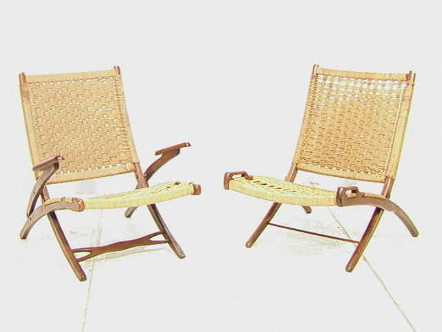 Pr HANS WEGNER style Folding Lounge Chairs. Woven: Pr HANS WEGNER style Folding Lounge Chairs. Woven cord seat and back. One with arms; one without. Unmarked. 2 PCS-- Dimensions: H: 31 inches: W: 27 inches: D: 31 inches --- Condition (General): Little