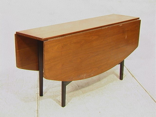 DUNBAR Drop Side Walnut Dining Table. Natural Wa: DUNBAR Drop Side Walnut Dining Table. Natural Walnut Top with Black Ebonized Legs. Metal DUNBAR tag.-- Dimensions: H: 28 inches: W: 60 inches: D: 53 inches --- Condition (General): Some chips to venee