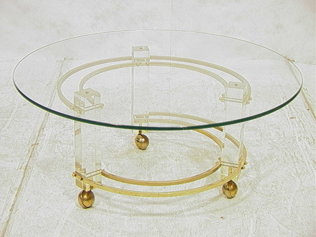 70s Modern Cocktail Coffee Table. Round Brass and: 70s Modern Cocktail Coffee Table. Round Brass and Lucite Base with .5" thick glass top.-- Dimensions: H: 16.5 inches: W: 40 inches --- Condition (General): Spotting to brass. Scratches and scuffs to L
