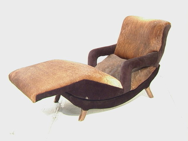 50s Modern Lounge Chair with Real Hide Upholster: 50s Modern Lounge Chair with Real Hide Upholstery. Wood legs.-- Dimensions: H: 33 inches: W: 27.5 inches: D: 65 inches --- Condition (General): Chips and scratches to wood. Please contact us with spec