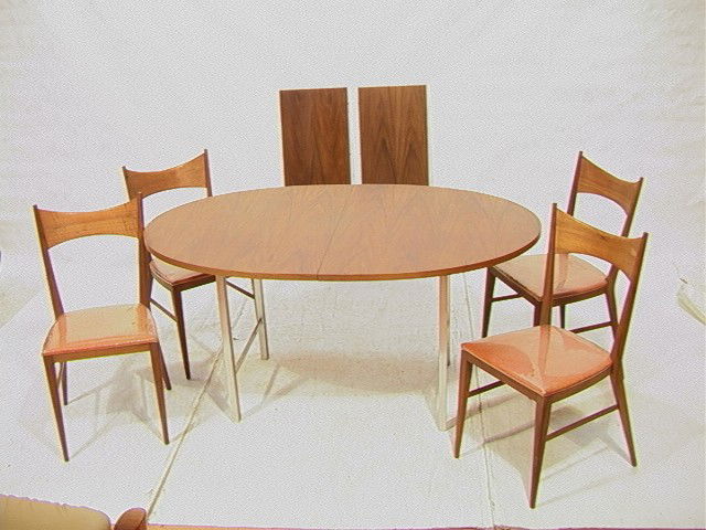 Paul McCobb Dining Set. Four Chairs and and an O: Paul McCobb Dining Set. Four Chairs and and an Oval Table. American Modern Walnut. Two 15 leaves.-- Dimensions: H: 29 inches: W: 62 inches: D: 40 inches --- Condition (General): Chairs need to be tigh