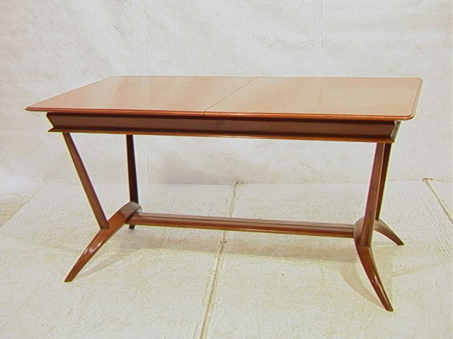 Warm Mahogany Dining Table GIO PONTI style. Styli: Warm Mahogany Dining Table GIO PONTI style. Stylish Arched base. Shaped Stretcher. Beveled edge Table Top. Not Marked-- Dimensions: H: 32 inches: W: 63 inches: D: 37 inches --- Condition (General): Ve