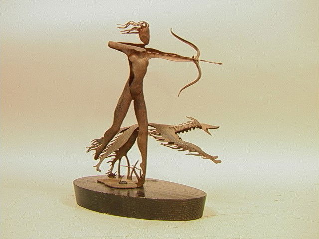 Heifetz Lamp Base. Cut steel female archer figure: Heifetz Lamp Base. Cut steel female archer figure with dog on black oak base. -- Dimensions: H: 12 inches: W: 11 inches: D: 6 inches --- Condition (General): Very Good Condition. Lamp works are missin