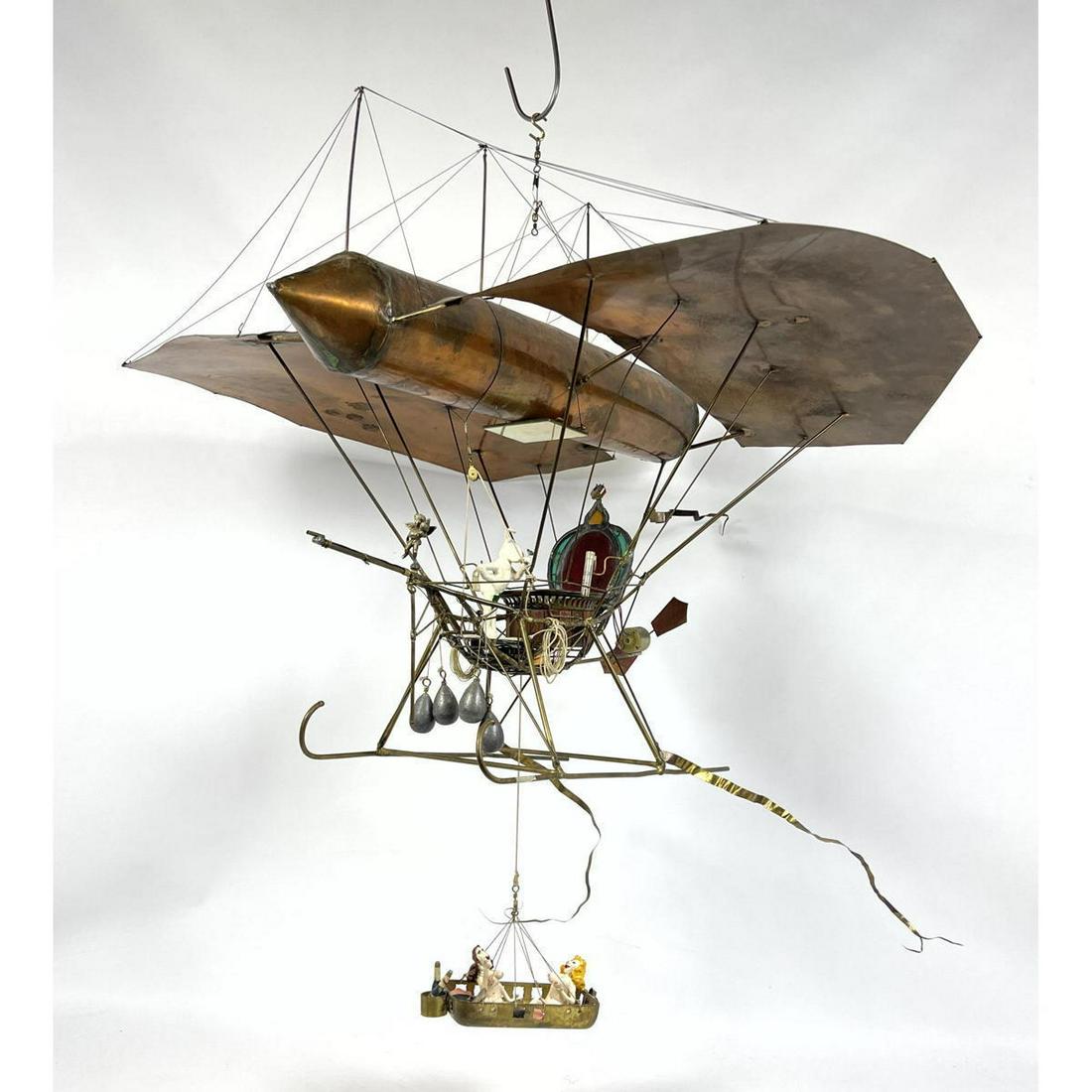 Mixed Metal Steampunk Flying Machine Sculpture. H Hangi: Mixed Metal Steampunk Flying Machine Sculpture. H Hanging. "The Playboy's Aerial Assignation". Has three figures. Playboy Rabbit and two nude female figures. Dimensions: H: 22 inches: W: 31 inches: D: