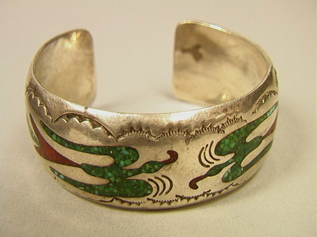 DJO Native American NAVAHO Silver Bracelet. Silve: DJO Native American NAVAHO Silver Bracelet. Silver Cuff Bracelet with stamped edge design and inlaid crushed Turquoise and Coral Bird Design. 7/8" wide. Marked DJO.-- Dimensions: --- US Shipping charg