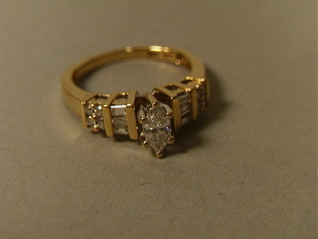 14K Gold Diamond Engagement style Ring. Solitaire: 14K Gold Diamond Engagement style Ring. Solitaire Marquise Diamond with 6 baguettes and 6 round Diamonds. -- Dimensions: --- US Shipping charge: $7