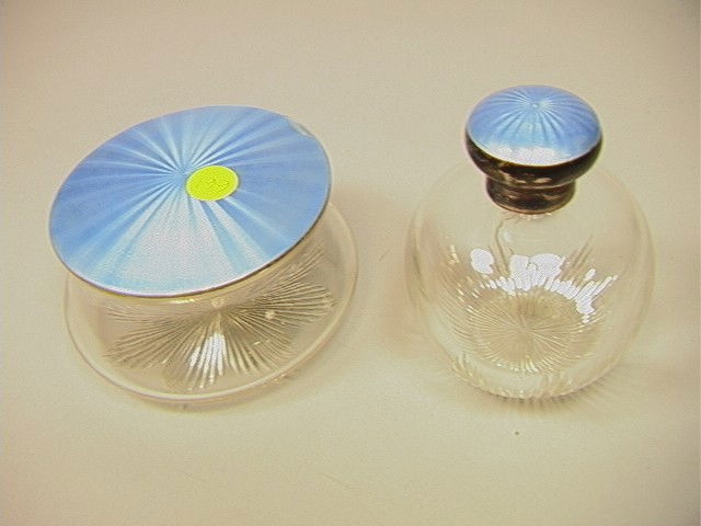 2 pcs Cut Glass Sterling Enamel Dresser Jars. One: 2 pcs Cut Glass Sterling Enamel Dresser Jars. One Scent Bottle Perfume with Blue enamel decoration. Matching Dresser Powder Jar. Marked Mappin & Webb. -- Dimensions: H: 2.5 inches: W: 4.5 inches --- U