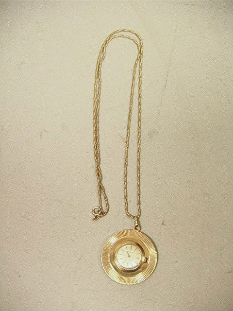 MOVADO 14K Gold Pendant Watch on 14K Gold Chain.: MOVADO 14K Gold Pendant Watch on 14K Gold Chain. 17 Jewel. Disc watch on twisted rope chain. Marked.-- Dimensions: H: 1.5 inches: W: 1.5 inches--- Weight: 19.1 DWT --- Condition (General): Chain lengt