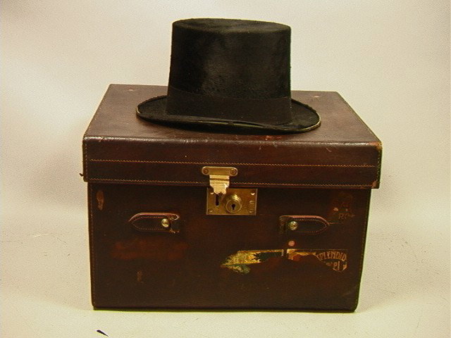 Vintage Leather Trunk with Top Hat. Trunk interio: Vintage Leather Trunk with Top Hat. Trunk interior fitted for hat. All Leather trunk with hotel labels.-- Dimensions: H: 11 inches: W: 17 inches: D: 14 inches --- Condition (General): Leather handle i