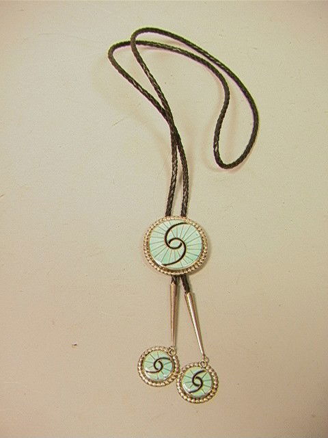 Native American Indian Bolo Necklace with Swirl D: Native American Indian Bolo Necklace with Swirl Design. Inset Turquoise. Medallion is 2 inches. -- Dimensions: --- Condition (General): Very Good Condition. Please contact us with specific questions a