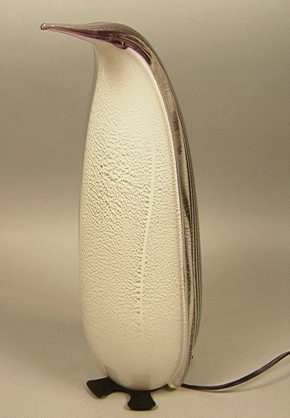 Large Murano Art Glass Penguin Sculpture Lamp. In: Large Murano Art Glass Penguin Sculpture Lamp. Internal Silver Leaf Decoration. Metal Base has feet and tail.-- Dimensions: H: 18.5 inches: W: 7.5 inches --- Condition (General): Very Good Condition. 