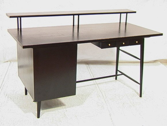 Paul McCobb Desk with Upper Shelf. Tapered Legs.: Paul McCobb Desk with Upper Shelf. Tapered Legs. One door with interior drawers. Black Finish. -- Dimensions: H: 29.25 inches: W: 60 inches: D: 28 inches --- Condition (General): Wear to top and edges