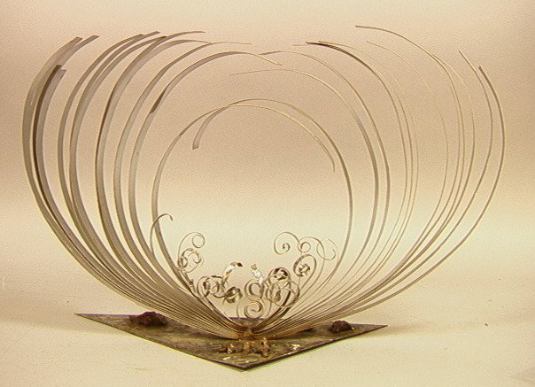Signed Welded Chrome Steel Table Sculpture. Kine: Signed Welded Chrome Steel Table Sculpture. Kinetic. Swirl design Engraved on Base. Marked with Initials.-- Dimensions: H: 13 inches: W: 20 inches --- Condition (General): Spots to metal. Please conta