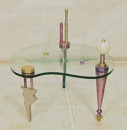 American Studio Glass & Anodized Aluminum Table.: American Studio Glass & Anodized Aluminum Table. Cocktail Coffee Table. Thick Shaped 3/4" Glass Top supported by Decorative Anodized Aluminum Legs.-- Dimensions: H: 31.5 inches: W: 34 inches: D: 34 in