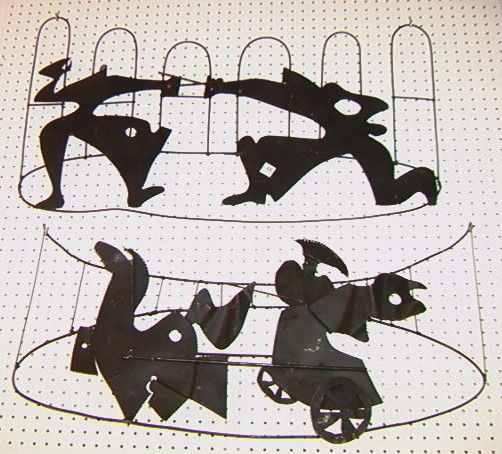 2 Metal Wall Sculptures. HEIFETZ style: 2 Metal Wall Sculptures. HEIFETZ style. One Charioteer. One People Fencing. -- Dimensions: H: 15 inches: W: 37 inches: D: 3 inches --- Condition (General): Very Good Condition. Some rust and losses to