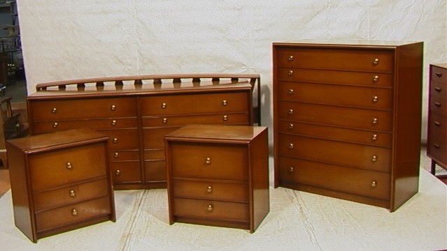 American Modern John Stuart Bedroom Set. Tall Ch: American Modern John Stuart Bedroom Set. Tall Chest, Low Dresser, Two Nightstands and Headboard. Brass hardware. -- Dimensions: --- Condition (General): Loss and chips to edges. Some finish scratches
