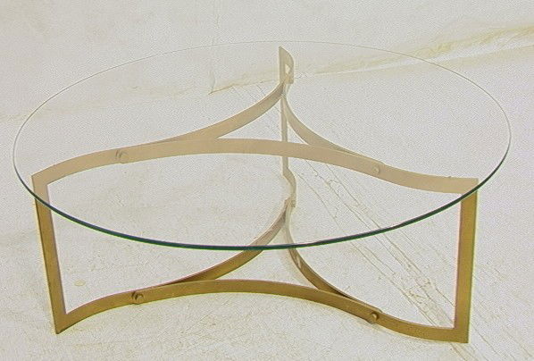 70's Modern Coffee Cocktail Table. Brass Base in: 70's Modern Coffee Cocktail Table. Brass Base in wave form with glass top. Flat metal.-- Dimensions: H: 15 inches: W: 42 inches --- Condition (General): Some wear and finish losses to metal. Please co