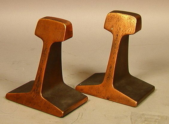 Pr. Bronze Industrial I Beam Bookends: Pr. Bronze Industrial I Beam Bookends. Style of Carl Aubock. Fronts polished to a copper color. Unmarked.Unmarked.-- Dimensions: H: 7.75 inches: W: 5 inches: L: 3 inches --- Condition (General): Distr