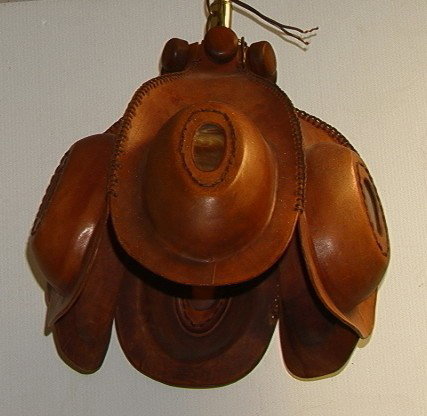 60's Mother Earth Leather Chandelier. Tooled Lea: 60's Mother Earth Leather Chandelier. Tooled Leather Hanging Light. Inset slag glass panels.-- Dimensions: H: 13 inches: W: 16 inches: D: 17 inches --- Condition (General): Very Good Condition. Please