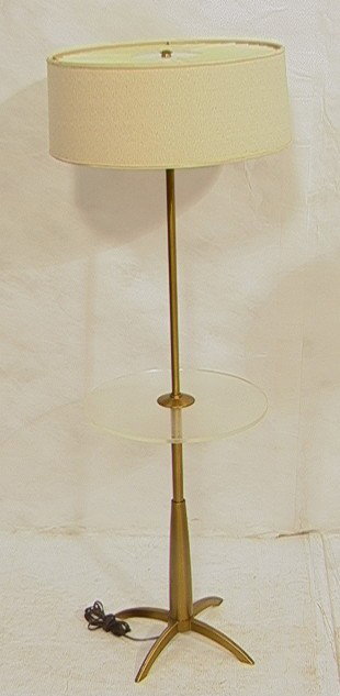 Modernist Brass Lucite Table Floor Lamp. Brass 4: Modernist Brass Lucite Table Floor Lamp. Brass 4 legged base. Column Form with round clear lucite table.-- Dimensions: H: 49 inches: W: 14.5 inches --- Condition (General): Lots of small scratches to 
