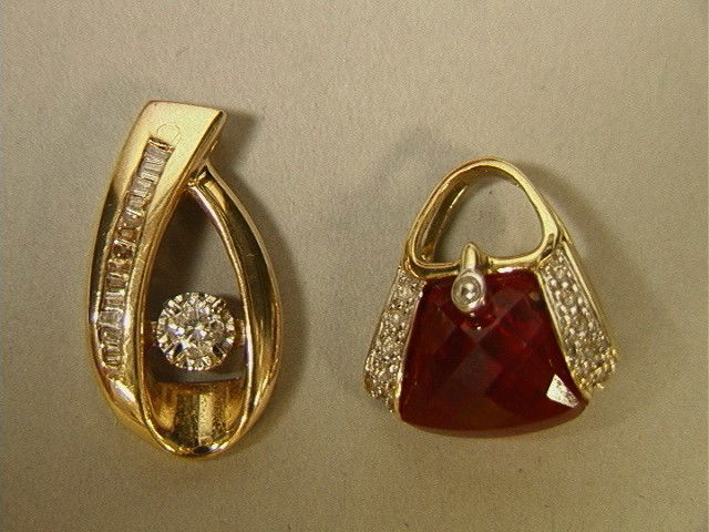 2 Gold Diamond Pendants 14K Gold. (1) 14K YG Swis: 2 Gold Diamond Pendants 14K Gold. (1) 14K YG Swish with Round Diamond & side baguettes. (2) 10K YG Purse Pendant with Faceted Red Stone & Small Diamond Accents. Both Marked. 2 PCS.-- Dimensions: --- W