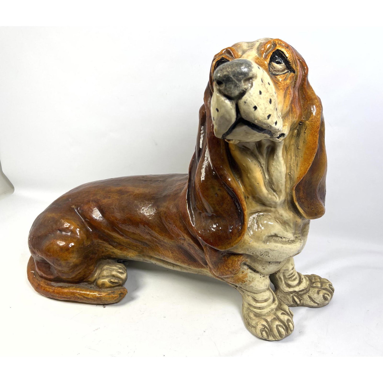 Large basset hound figure statue. Constructed of hollow composition.: Large basset hound figure statue. Constructed of hollow composition. Dimensions: H: 21.5 inches: W: 28 inches: D: 16 inches ---