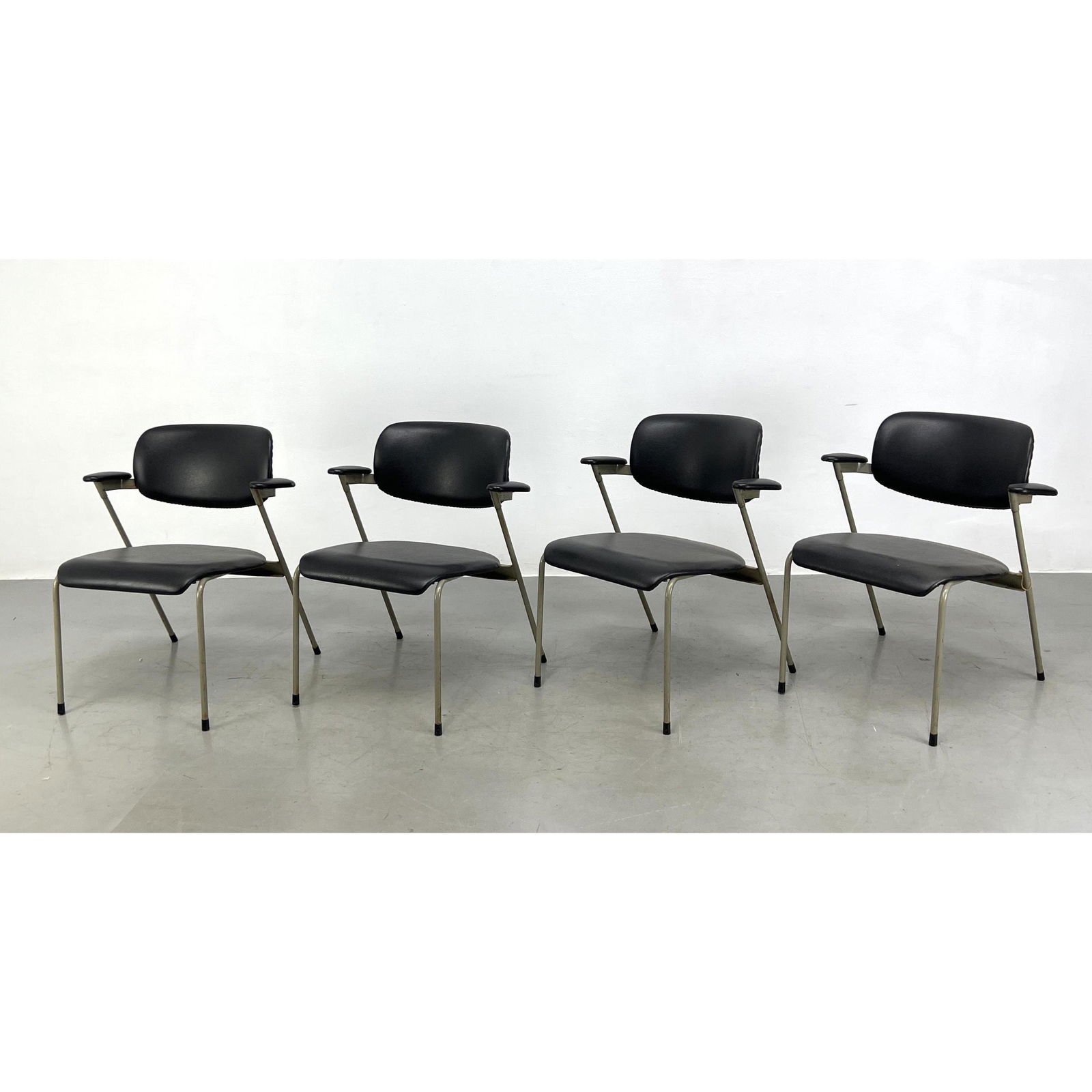 Set of 4 dining chairs by Willy van der Meeren. Black vinyl upholstery on gray metal frame. Made by (1 of 12)